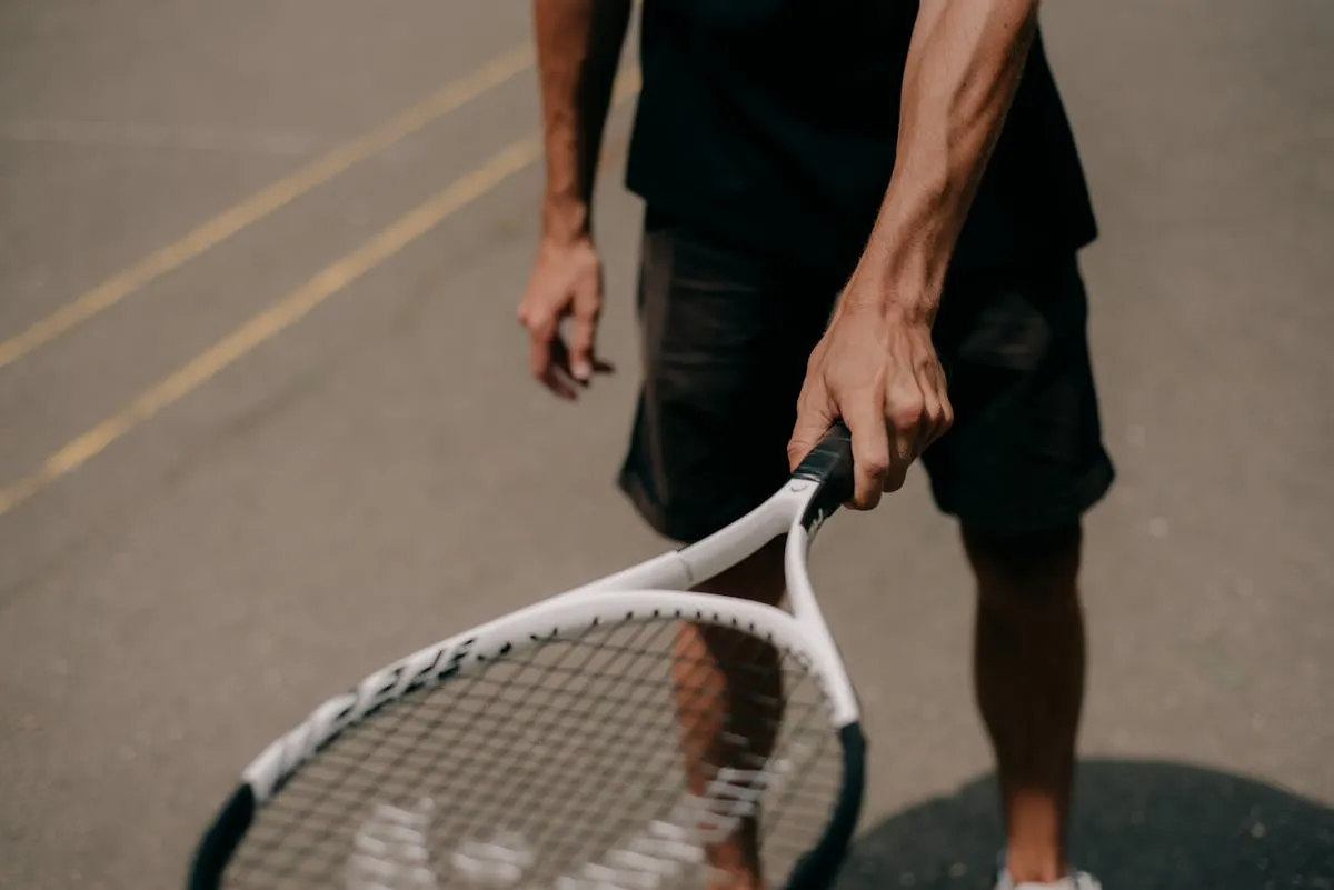Tennis player experiencing elbow pain from lateral epicondylitis